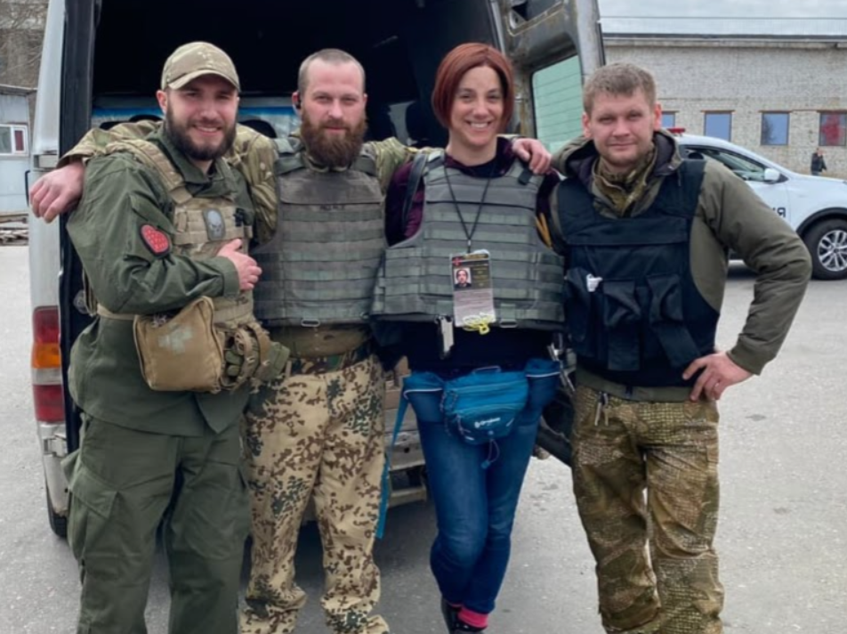 LGBTQ Nation journalist Sarah Ashton-Cirillo poses with members of the Ukrainian Armed Forces