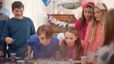 a snapshot of Matt Walsh's documentary where two children are blowing out candles on a birthday cake. the boys all wear blue and the girls all wear pink