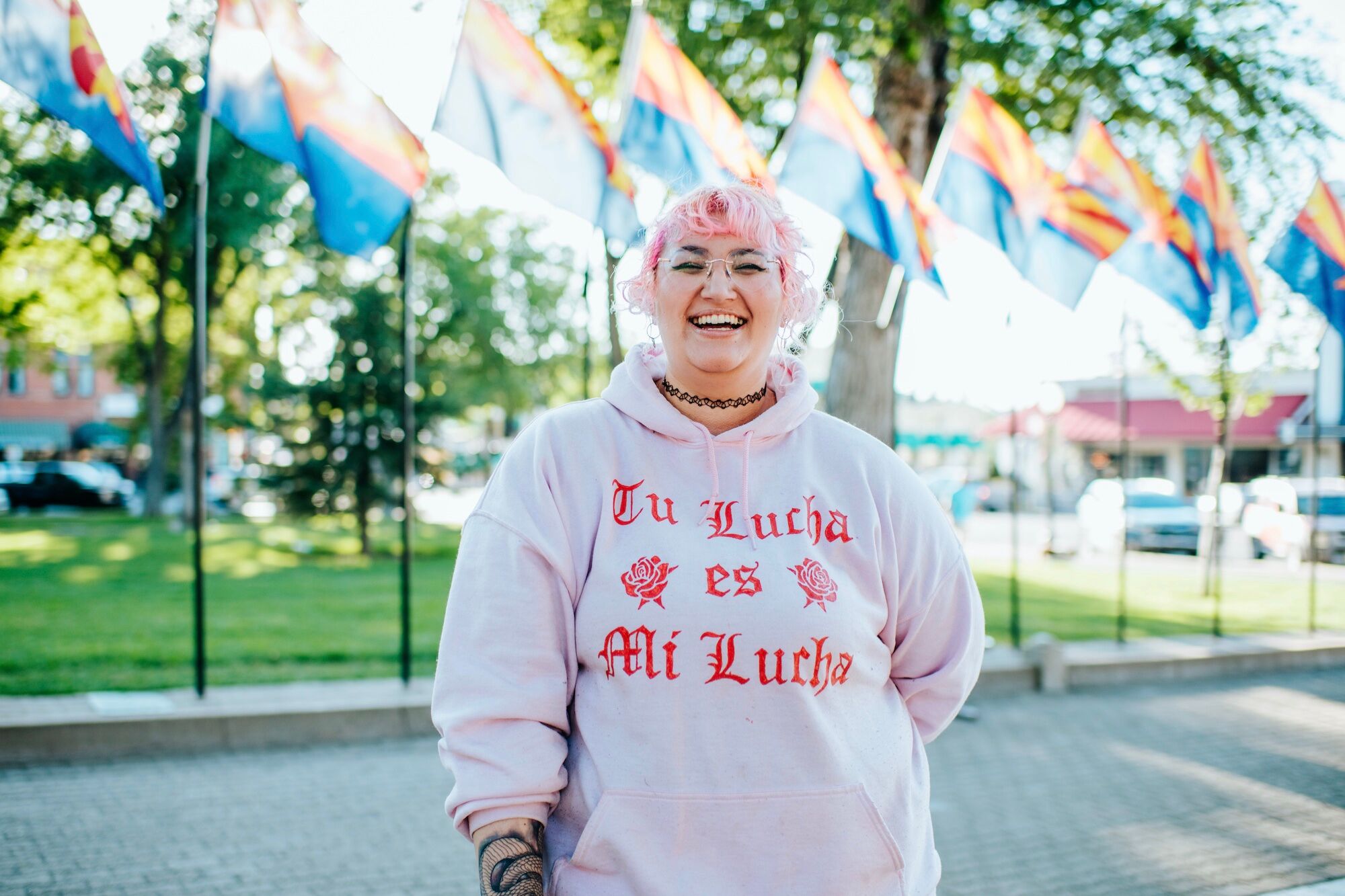 Silvia Ximi wears a sweatshirt she created, which translates to “your struggle is my struggle” in Prescott, Arizona on July 18, 2022. Photo by Parker Micheaels Photography for LGBTQ Nation