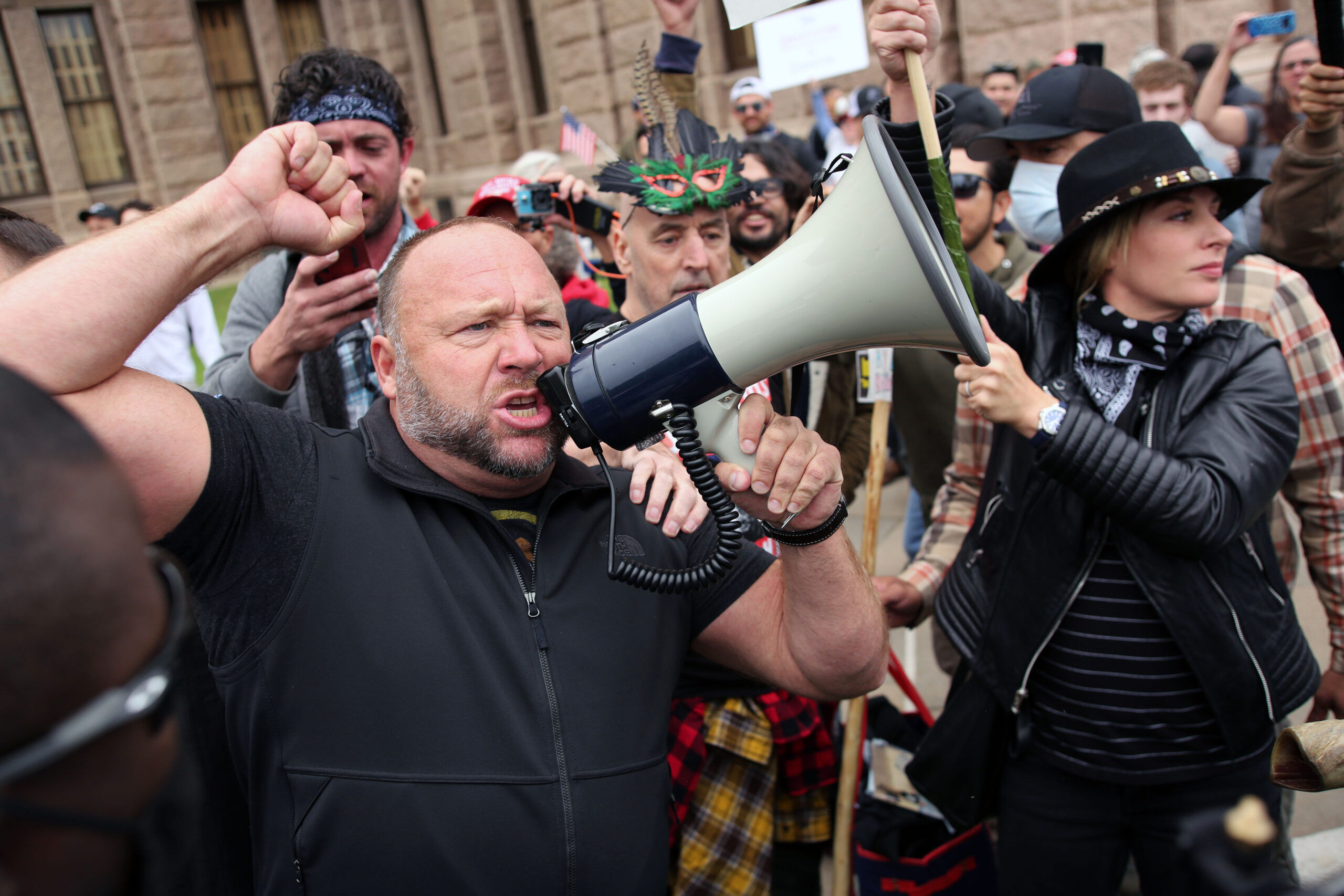 Austin, Tx/USA - Apr. 18, 2020: Alex Jones addresses demonstrators protesting Covid-19 stay at home orders at a rally at the Capitol heavily promoted by his Infowars website.