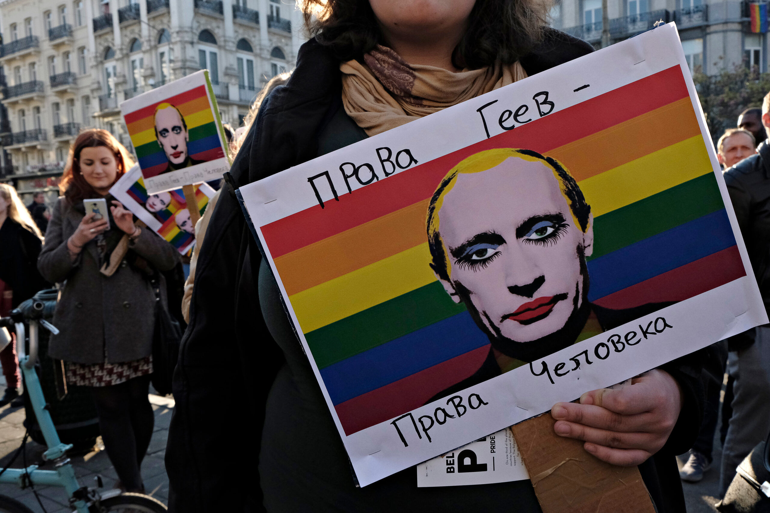 Brussels, Belgium March 20, 2017. A woman holds a placard with an image of Russian President Vladimir Putin during protest against the detention of gay men in concentration camps in Chechnya.