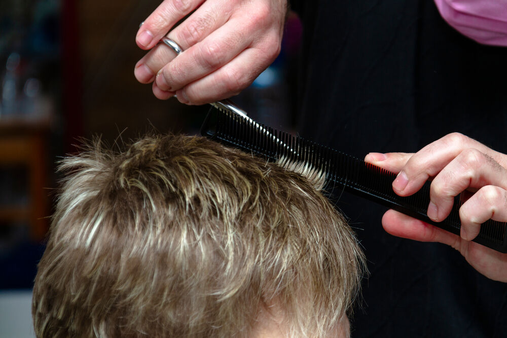 a person getting a haircut