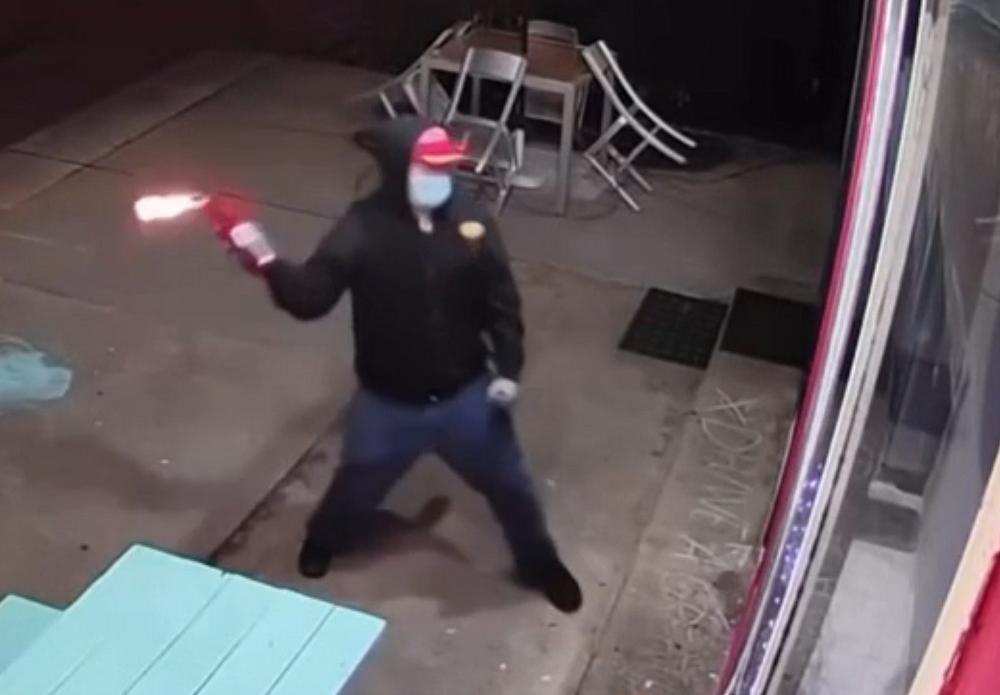 The suspect throwing a Molotov cocktail in The Donut Hole