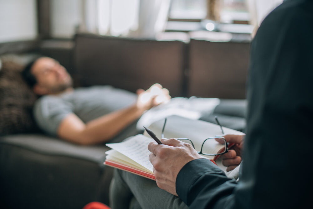 A client on a couch talking to a therapist