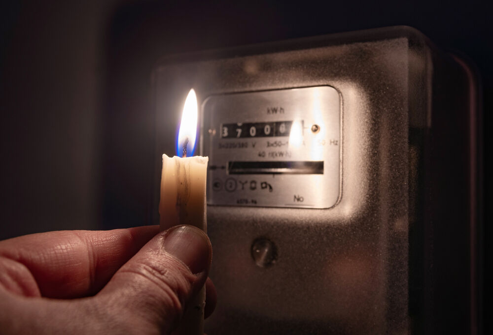 A candle by an electricity meter