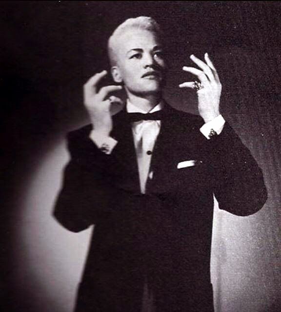 Storme Delevarie wearing a tux in the middle of a movement