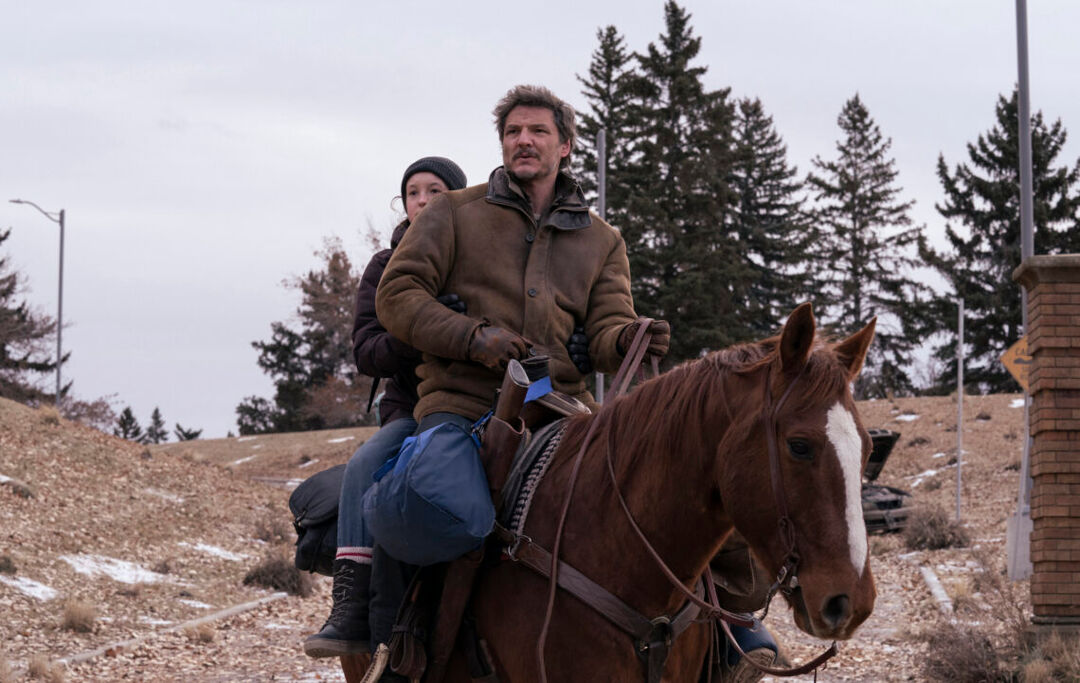 pedro pascal and bella ramsay on a horse in the wilderness