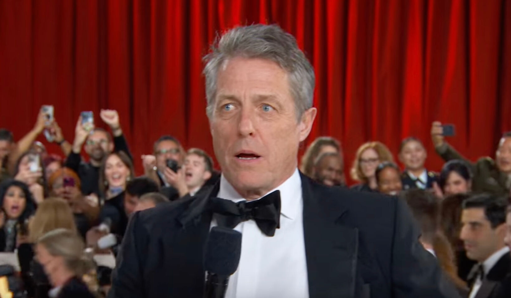 A close read of Hugh Grant’s painfully awkward Oscars red carpet interview