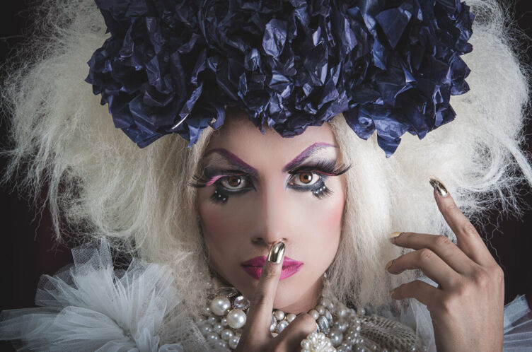drag queen with finger over mouth