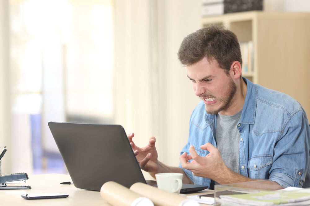 A man angry in front of his computer