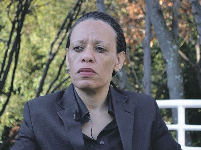 Beverley Palesa Ditsie sitting outdoors and looking off to the side