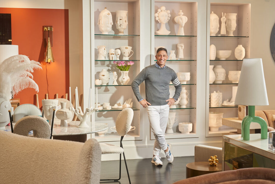 Jonathan Adler stands in front of pottery pieces from his Muse collection at his SoHo, New York, retail store. Photo by Seth Caplan for LGBTQ Nation