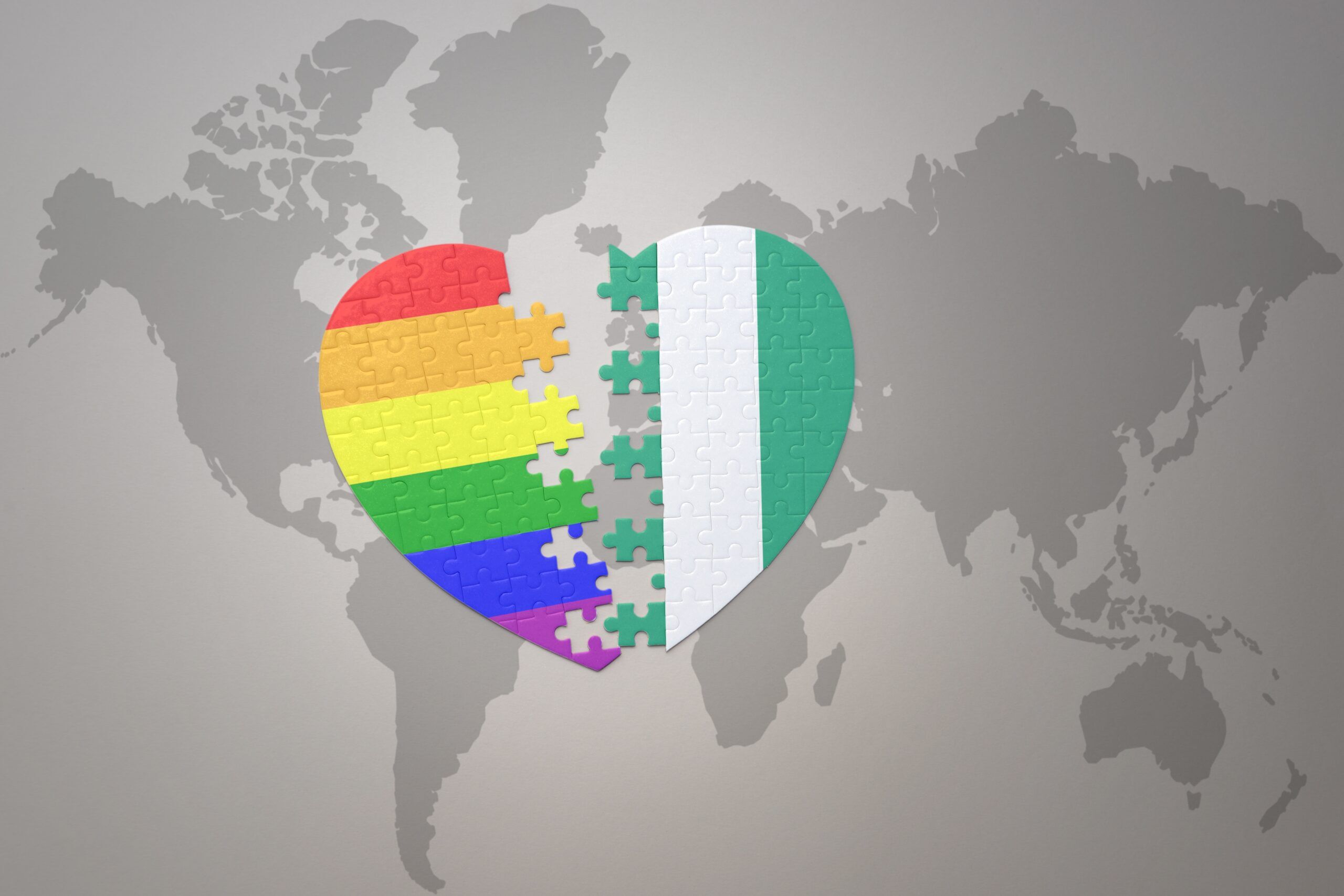 puzzle heart with the rainbow gay flag and nigeria on a world map background. Concept.