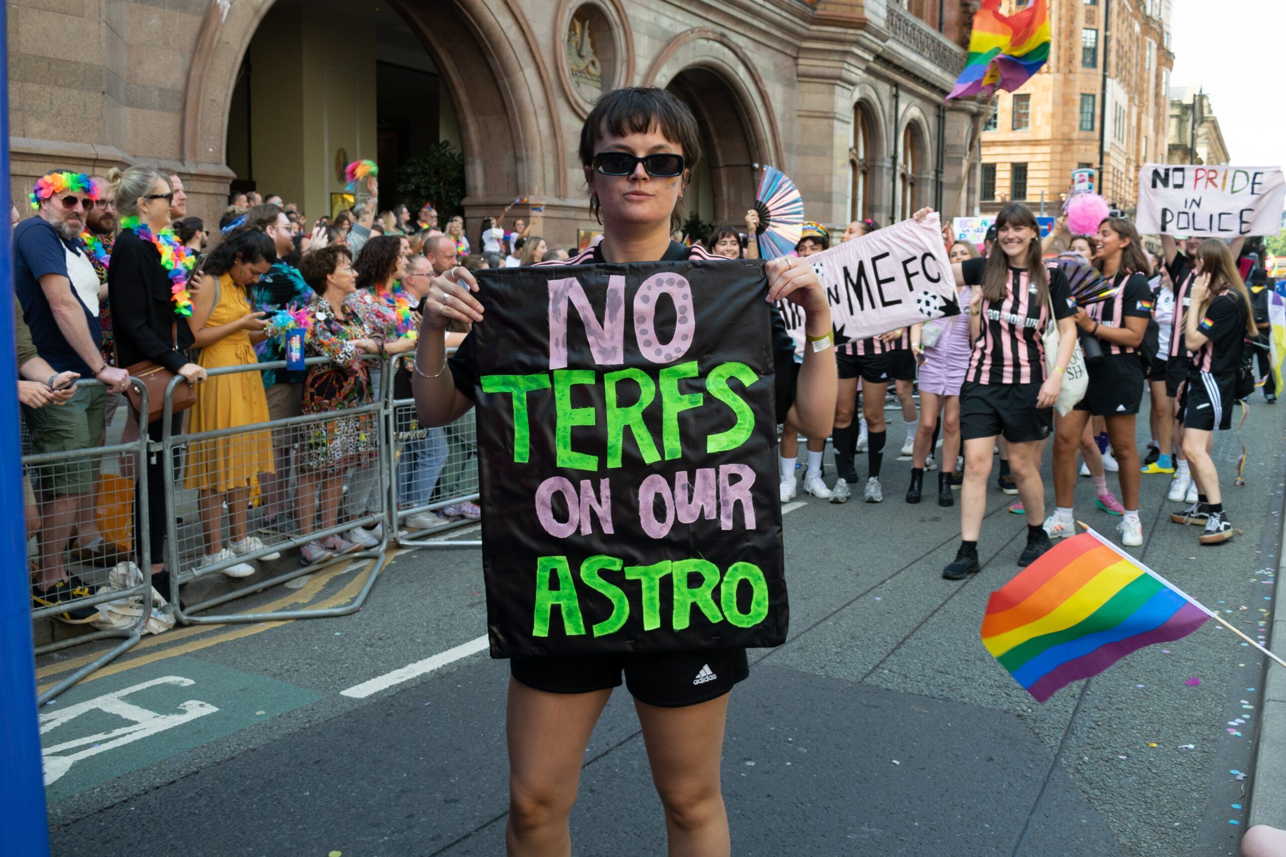 a protestor with a sign that says "No terfs on our astro"
