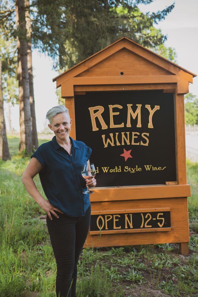Remy Drabkin stands in front of the "Remy Wines" sign 