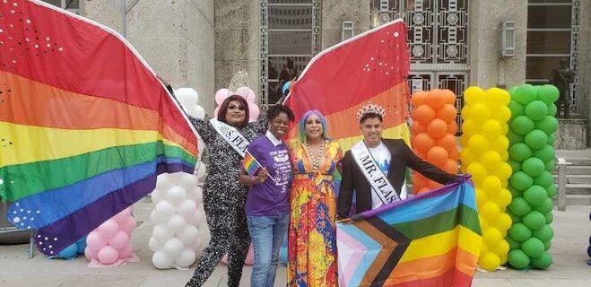 a group of people donned in rainbow apparel celebrating Houston Pride