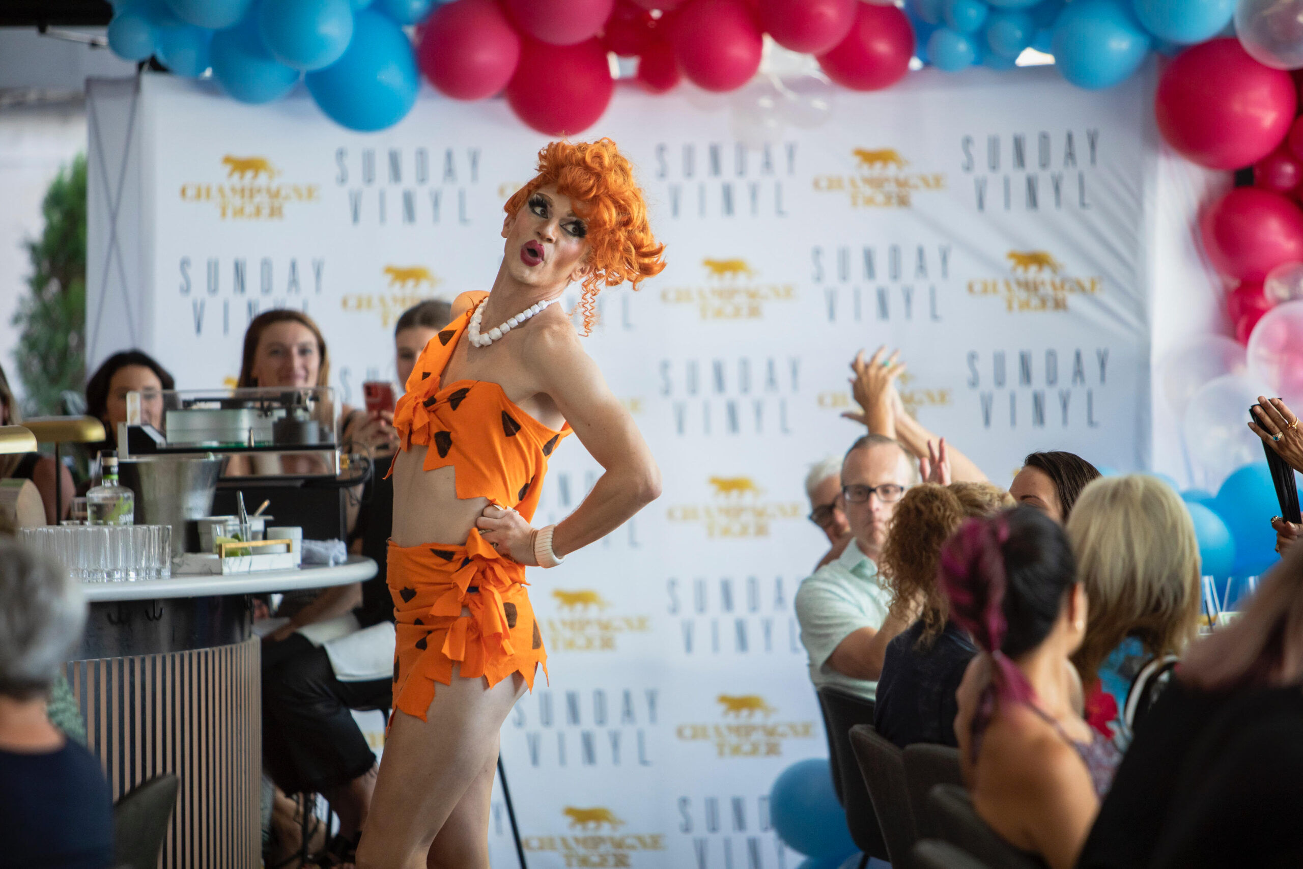 Pony the drag queen performing in a Flintstone ensemble