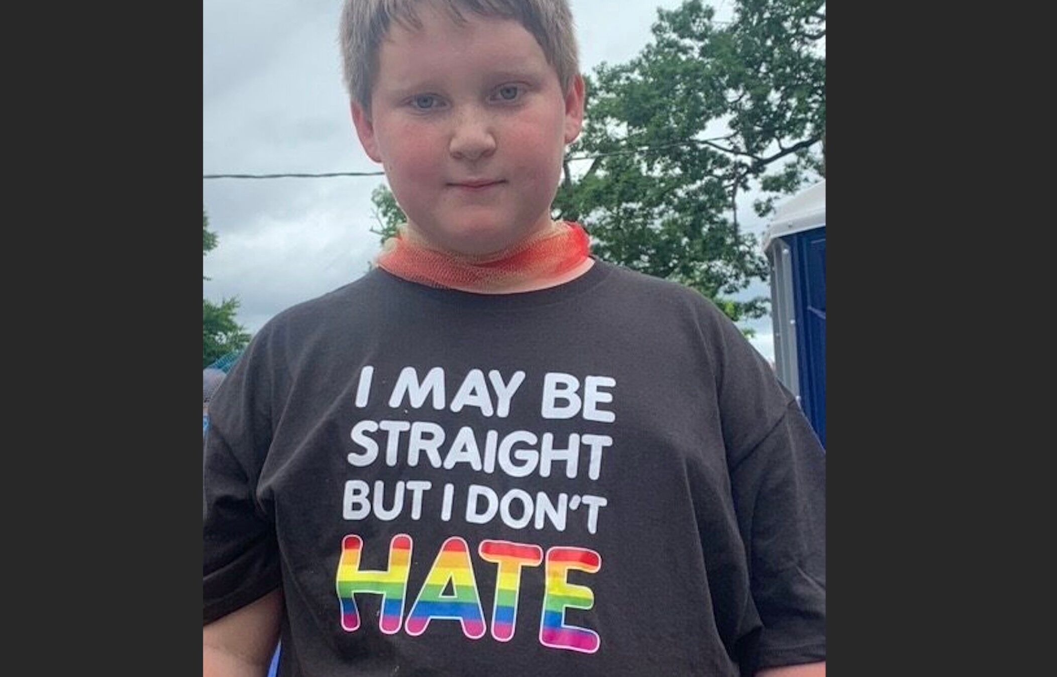 A teenaged parade-goer in Portland, Maine wears a t-shirt proclaiming, "I may be straight, but I don't hate."