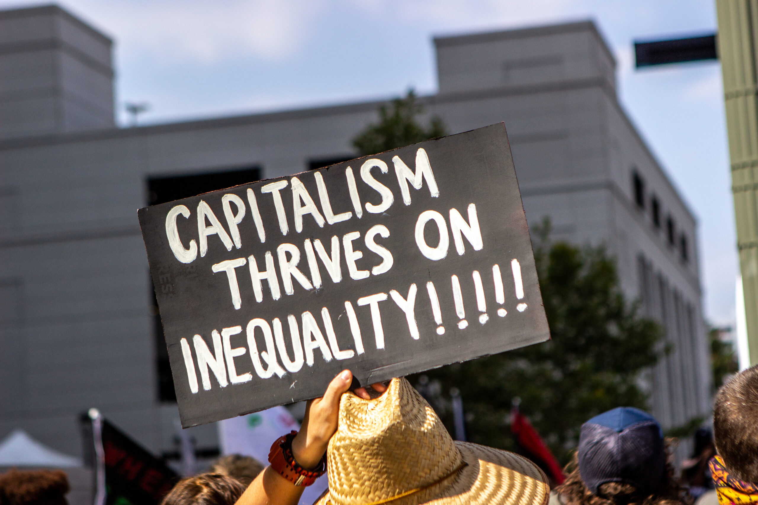 Los Angeles, CA / USA - June 17, 2020: Protester holding a 'Capitalism Thrives on Inequality' sign at the Black Lives Matter Los Angeles protest again District Attorney Jackie Lacey