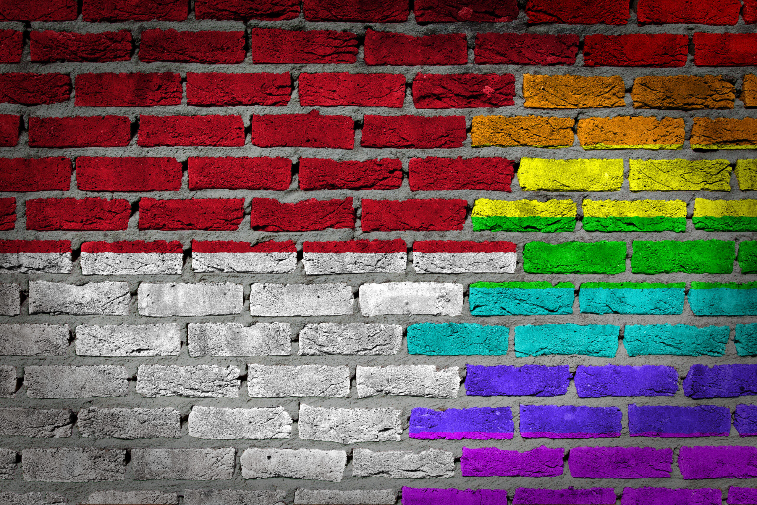 Dark brick wall texture - coutry flag and rainbow flag painted on wall - Indonesia