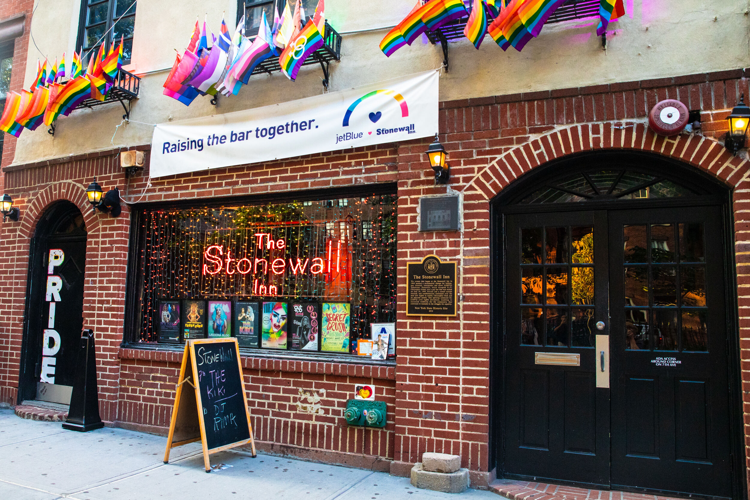 Honoring The Legacy Of The Stonewall Riots LGBTQ Nation   Stonewall In Facade With Flags 