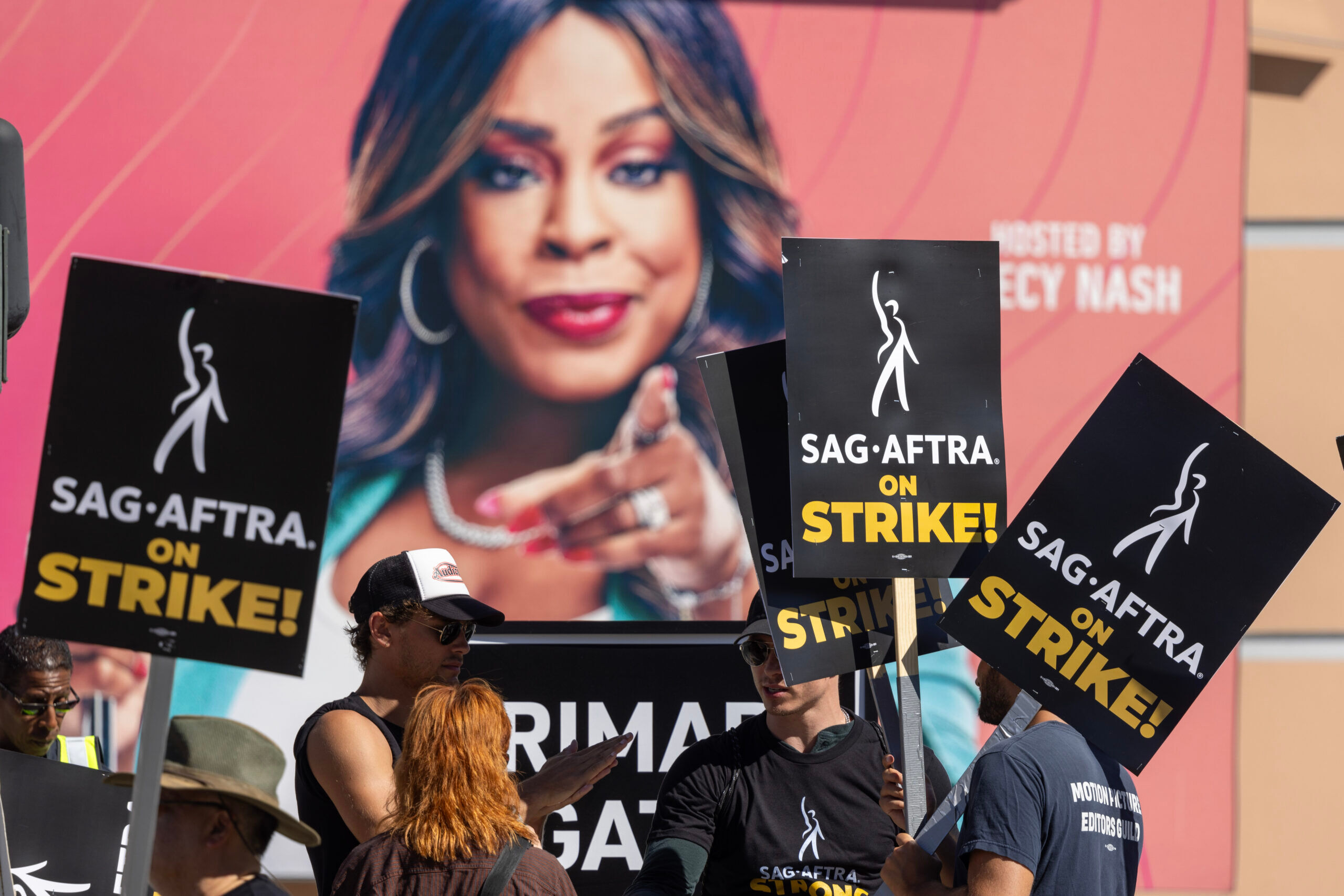 LOS ANGELES, CALIFORNIA - JULY 14: Members of the Hollywood actors SAG-AFTRA union walk a picket line near an image of "Don't Forget the Lyrics" host Niecy Nash outside of FOX Studios on the first day of the actors' strike on July 14, 2023 in Los Angeles, California. Members of SAG-AFTRA, Hollywood’s largest union which represents actors and other media professionals, joined striking WGA (Writers Guild of America) workers in the first joint walkout against the studios since 1960. The strike could shut down Hollywood productions completely with writers in the third month of their strike against the Hollywood studios.