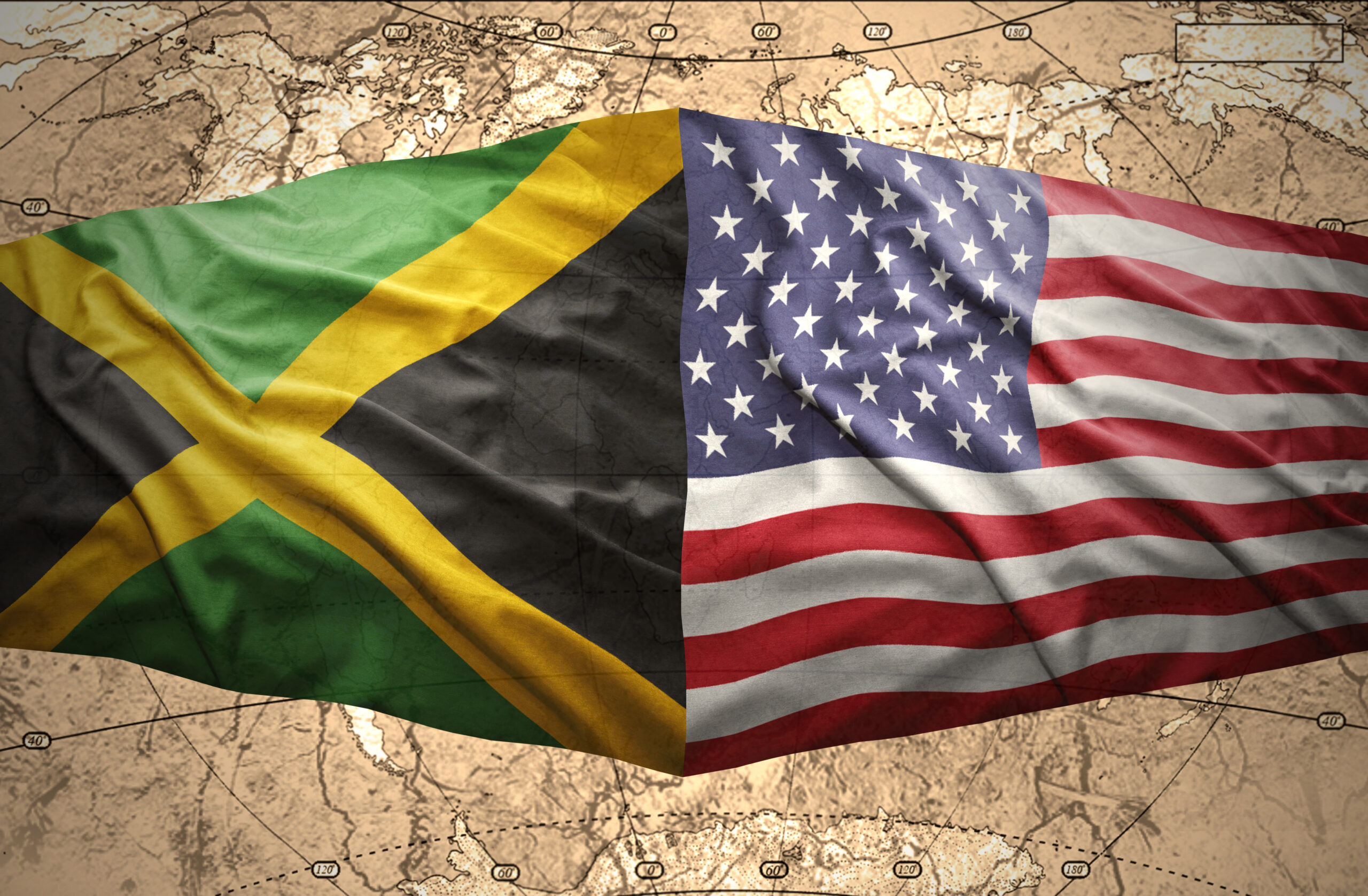 Waving Jamaican and American flags on the of the political map of the world