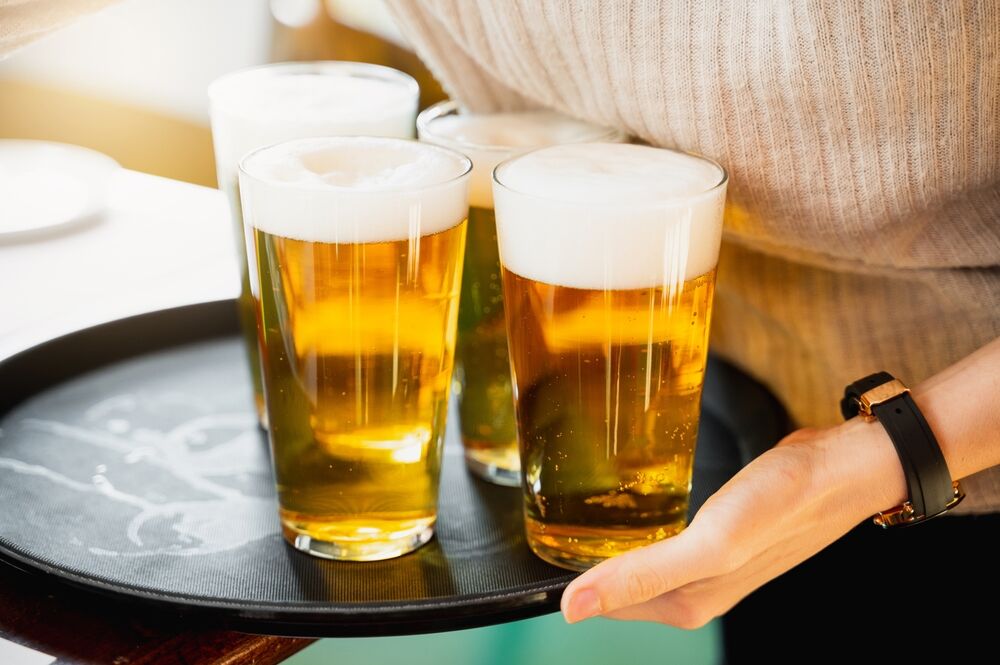 A waitress carrying beers