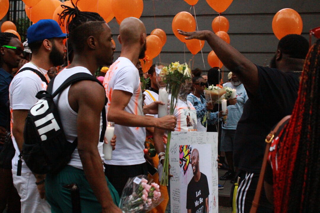 Mourners honor Sibley with orange balloons to represent his favorite color. Photo by Lana Leonard