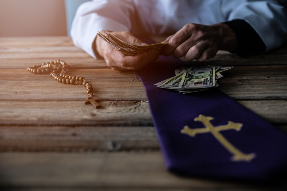 A priest counting money