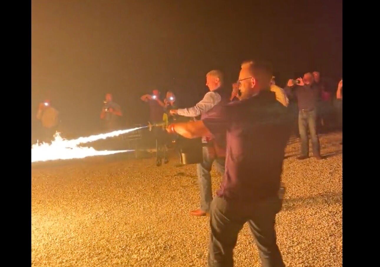 state Senators Nick Schroer and Bill Eigel using flamethrowers at a symbolic book burning in Missouri