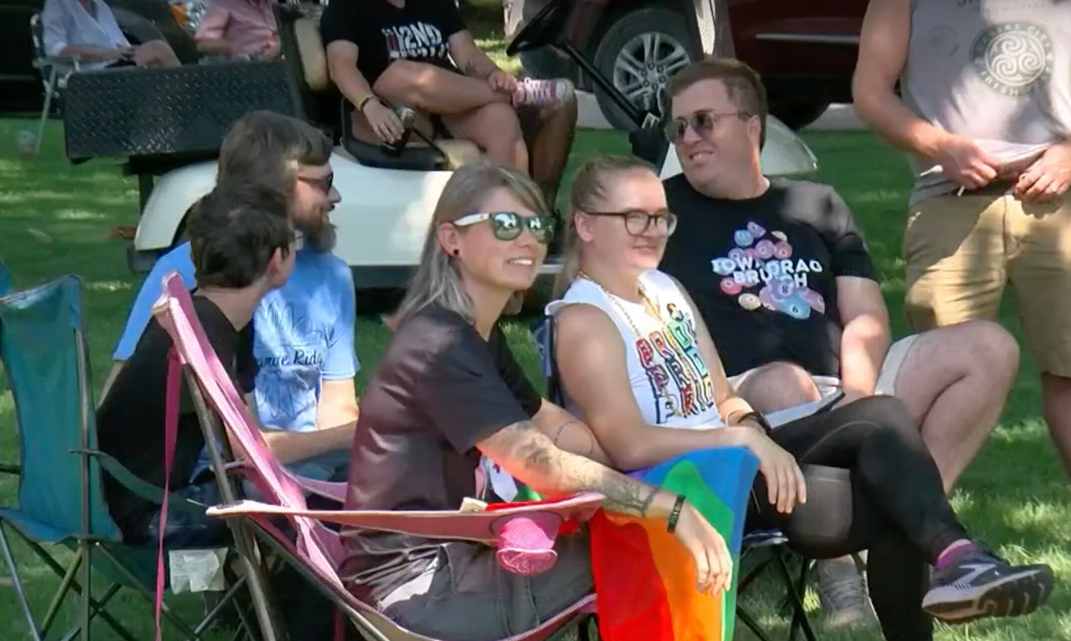 Members of Shenandoah Pride watch the Labor Day parade in Essex, Iowa.