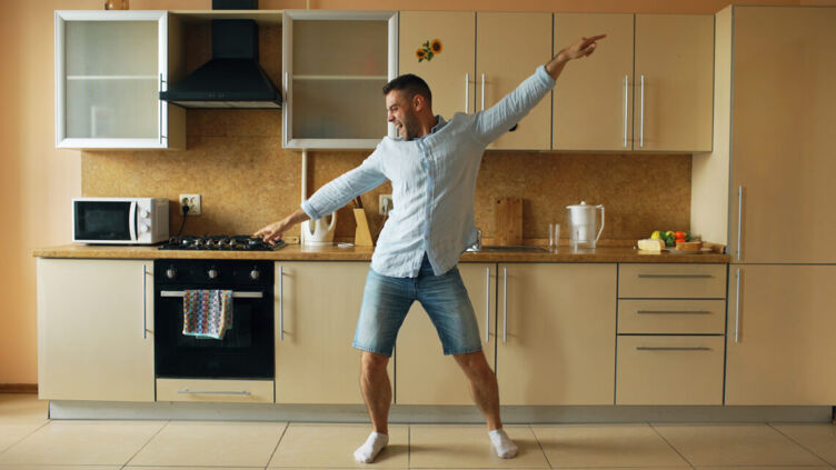 man dancing at home in kitchen