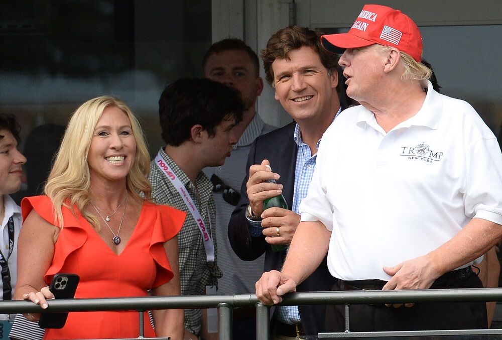 Rep. Marjorie Taylor Greene with Tucker Carlson and Donald Trump at the LIV Golf Bedminster tournament in July 2022