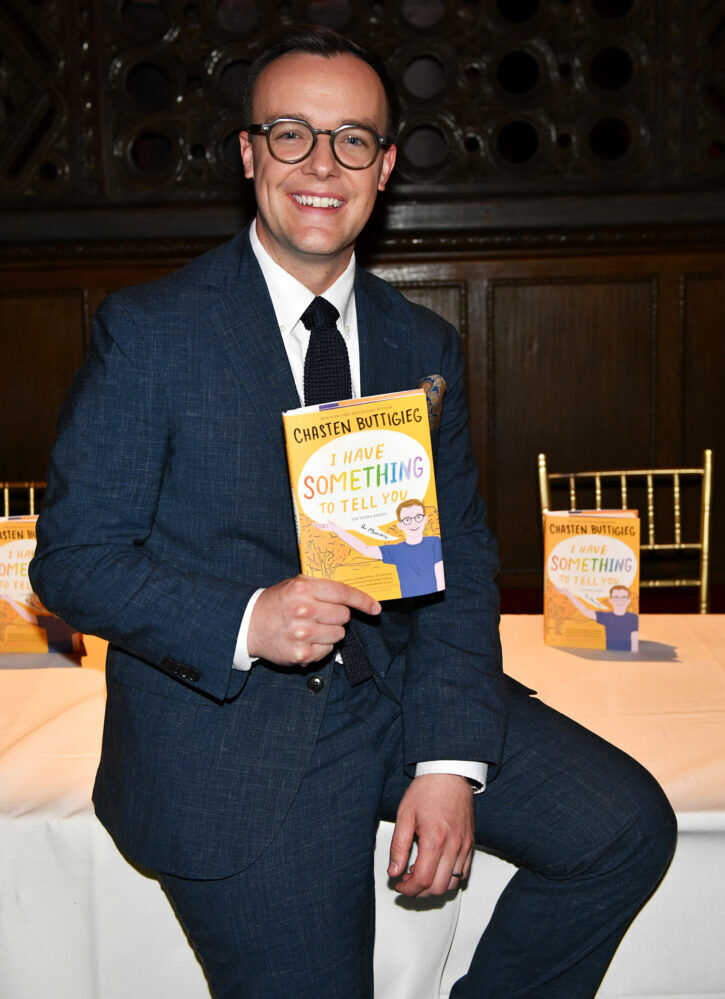 Chasten Buttigieg poses with his book, "I Have Something to Tell You: For Young Adults."