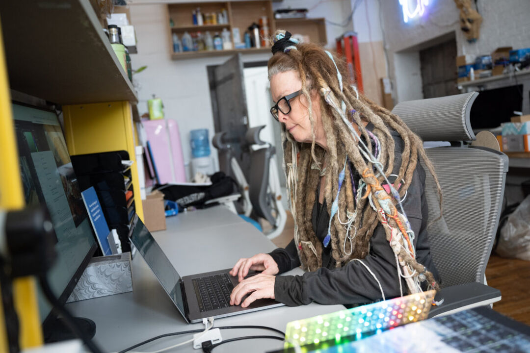 Moey co-founder Molly Lenore sits at a computer at the company's Brooklyn headquarters.
