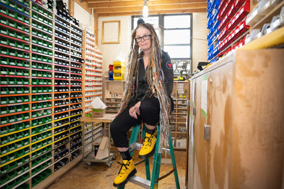 Moey co-founder Molly Lenore sits on a ladder in a storage room at the company's Brooklyn headquarters.