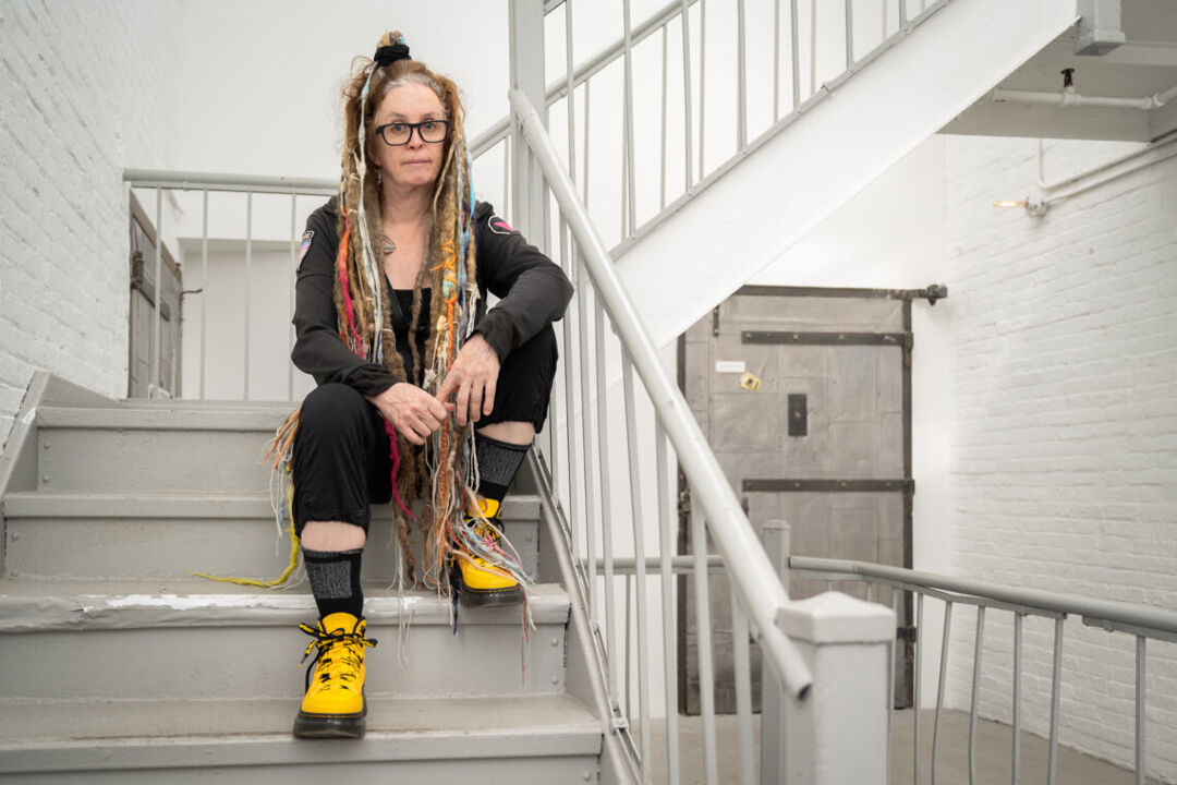 Moey co-founder Molly Lenore sits on a staircase at the company's Brooklyn headquarters.