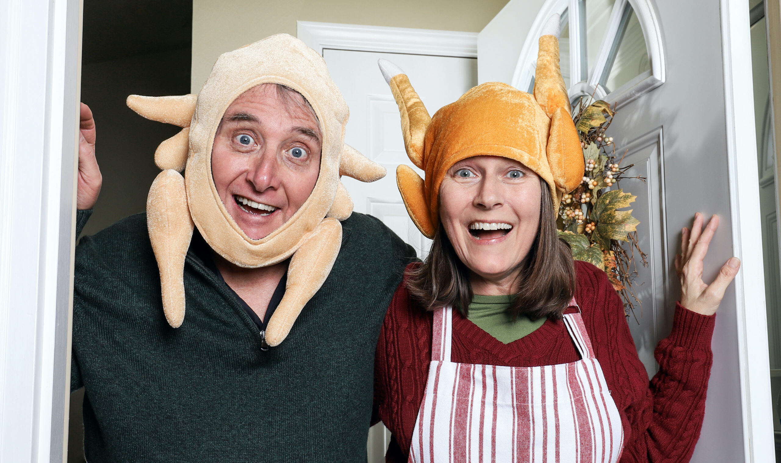 Annoying in laws wearing turkey hats welcoming family on the holiday