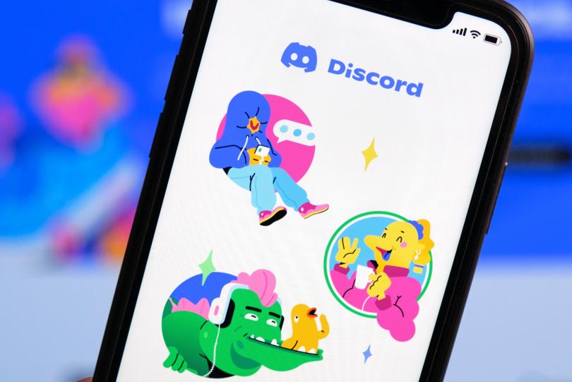 A smartphone shows the Discord app welcome page, showing four different anthropomorphic cartoon animals emerging out of colored circles.