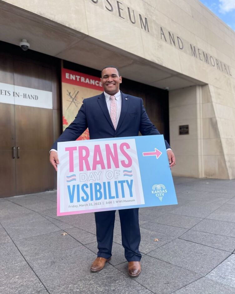 Justice Horn holds a sign that says Trans Day of Visibility
