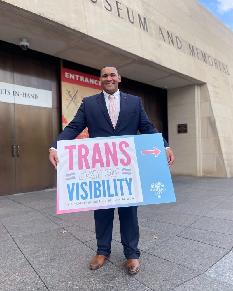 Justice Horn holds a sign that says Trans Day of Visibility