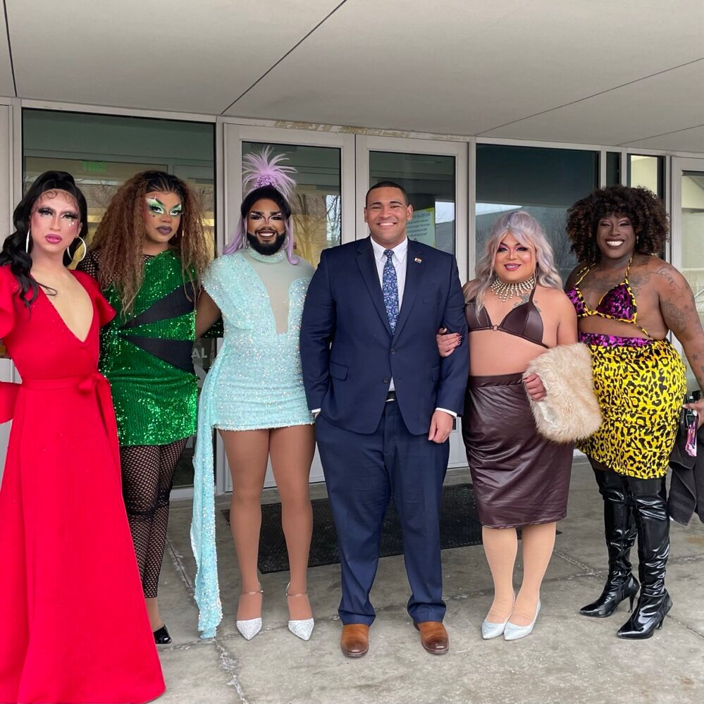 Justice Horn stands poses for a photo with 5 drag queens