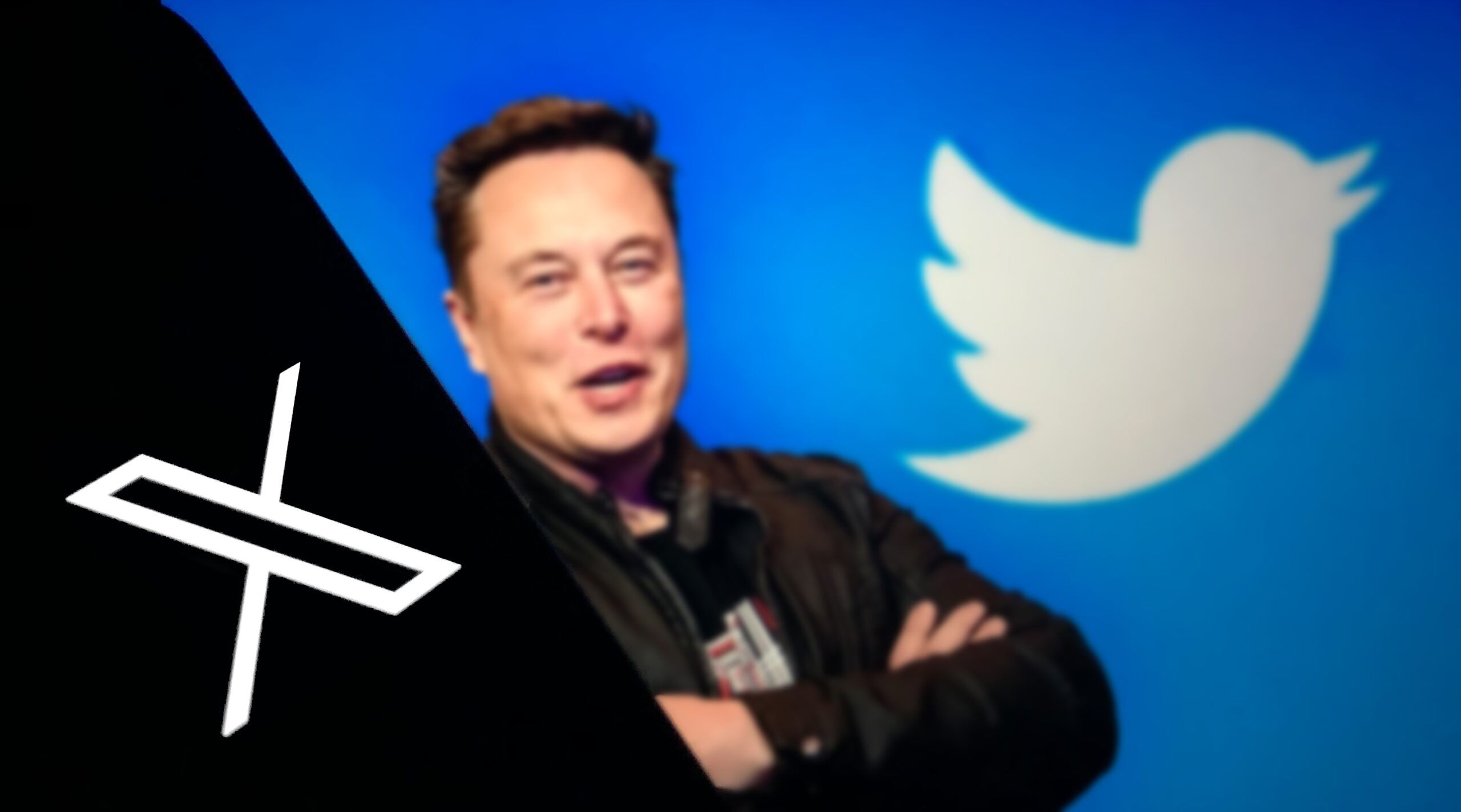 Elon Musk stands between the logos for X and Twitter