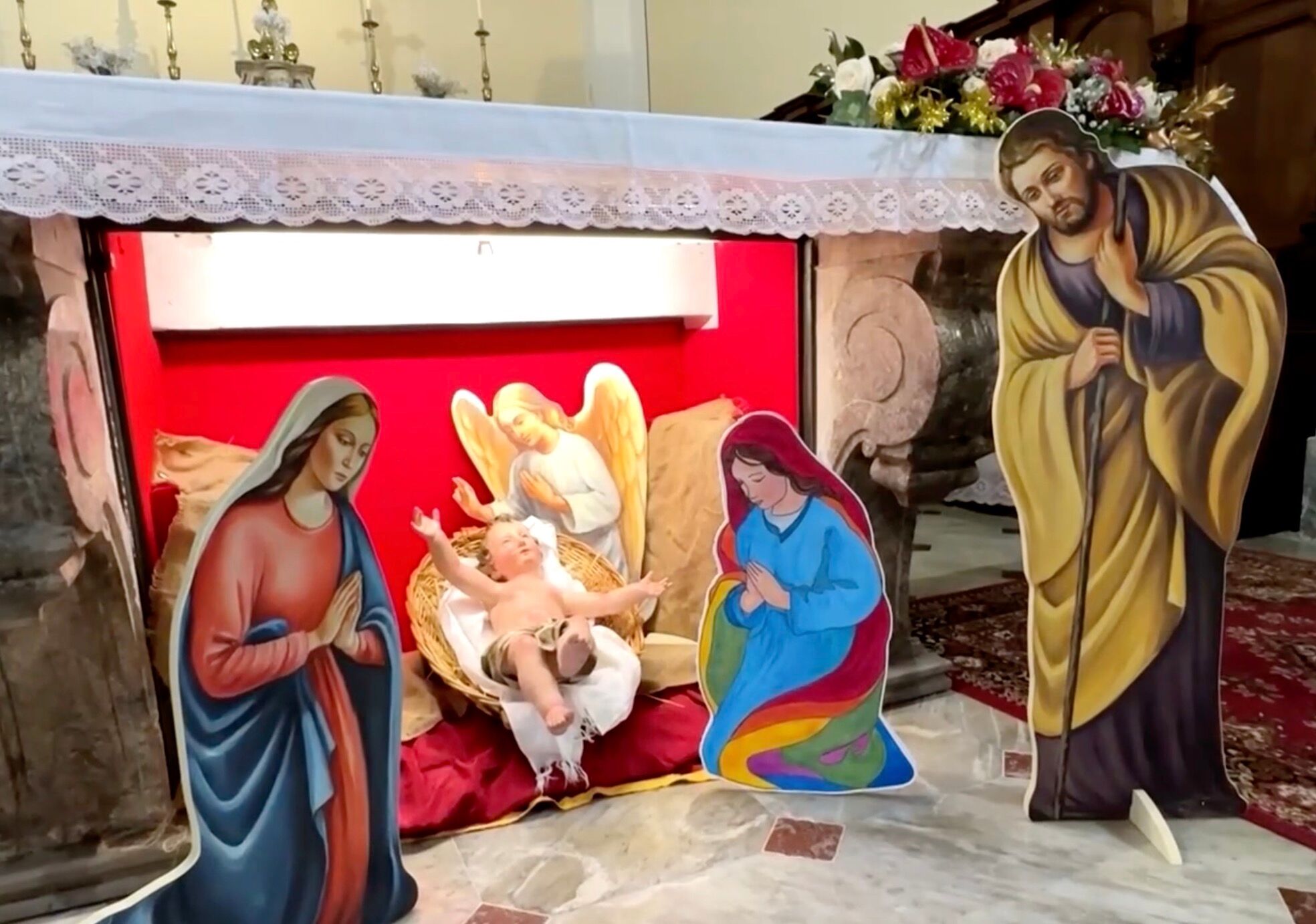 Nativity scene in Italy featuring the baby Jesus with two moms - the Virgin Mary and another woman wearing rainbow robes