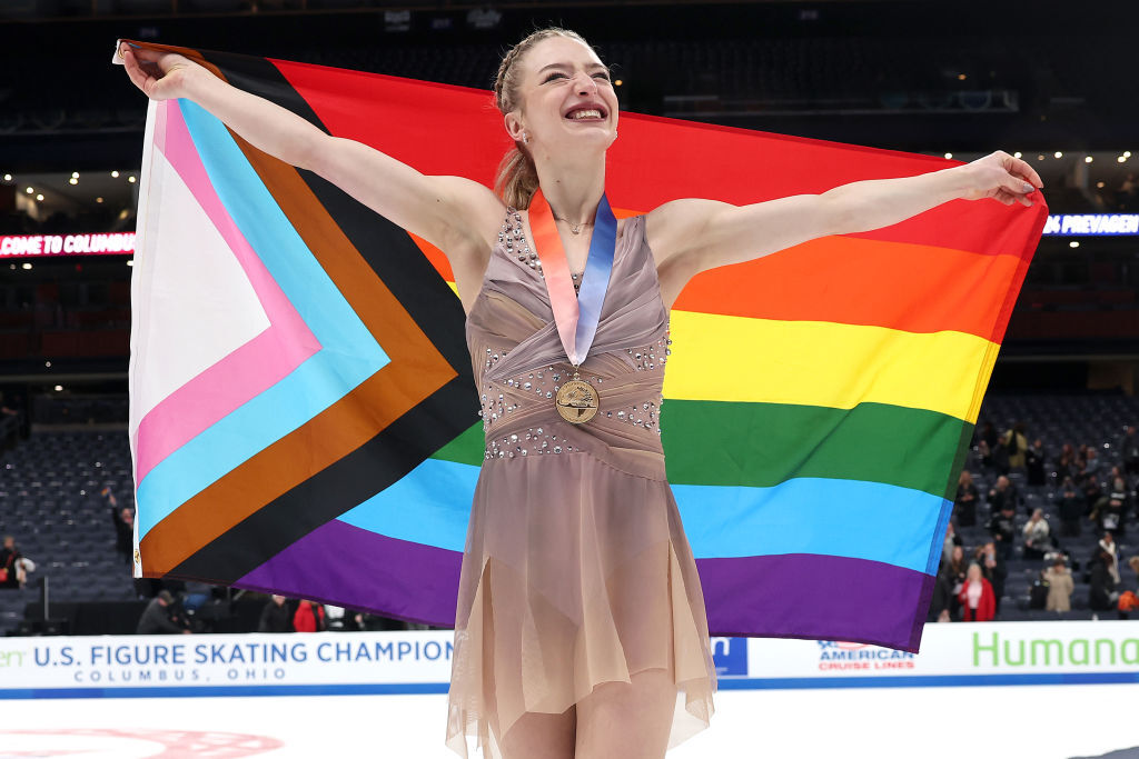 Champion figure skater makes history & unfurls Pride flag during gold