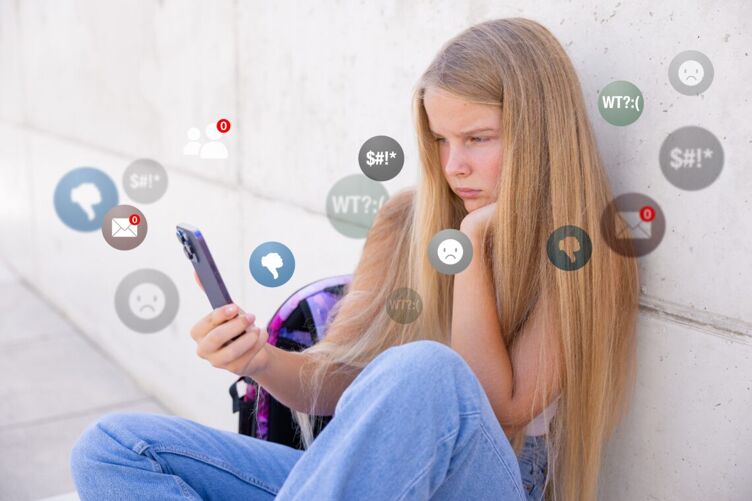 kosa-teen-girl-lgbtq-teens-censorship-social-media, A teen girl frowns while looking at thumbs down, frowny faces, zero messages, and other things on her smartphone