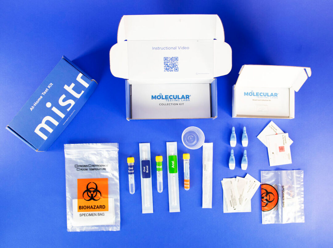 A photo of the contents of MISTR's at-home test kit on a blue background.