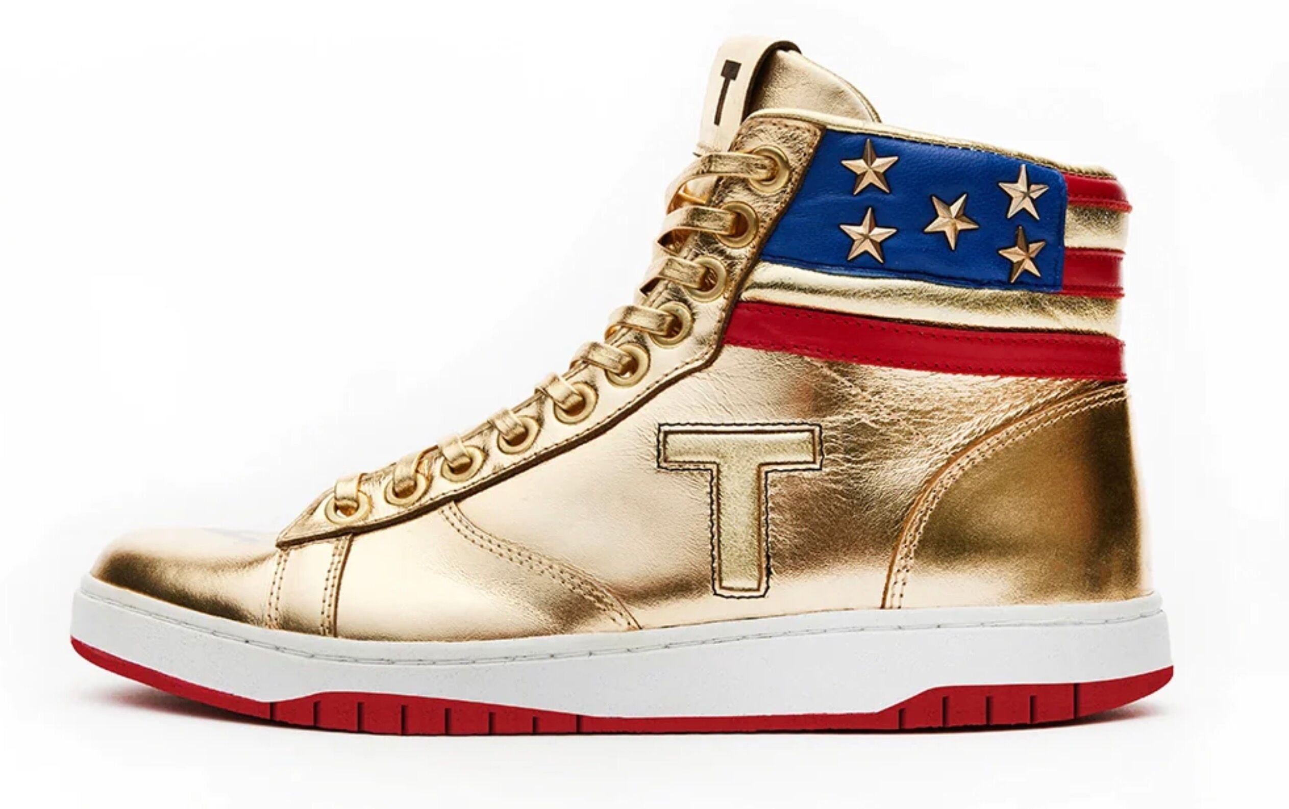 Donald Trump's new sneaker high top, shiny gold with a T on the side and an American flafg emblem on the ankle