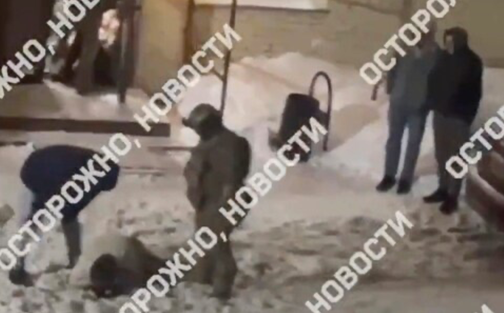 A plainclothes officer kicks and punches someone on the ground in video released on Russian media